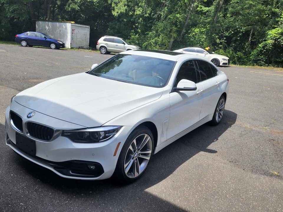 White BMW 4 Series with tinted windows
